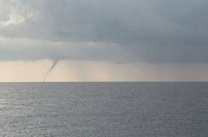 A waterspout hovering over the ocean