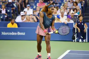 Serena Williams serving during a tennis match