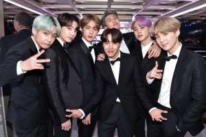 The members of BTS wearing tuxedos.