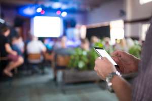 A student hesitates before joining a phone-free group.