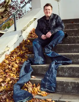 A man wearing very long jeans.