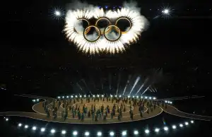 The opening ceremony at the Winter Olympics in Milan. The Olympic rings are above the athletes.