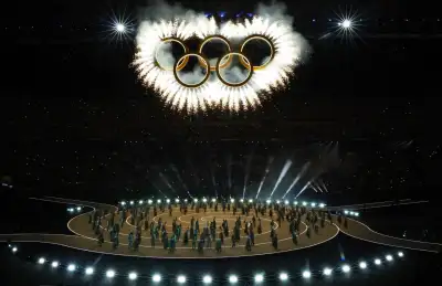 The opening ceremony at the Winter Olympics in Milan. The Olympic rings are above the athletes.