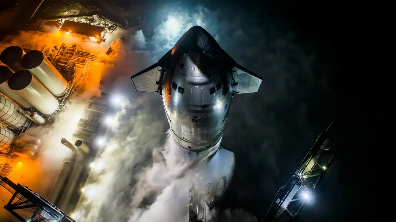 A rocket with steam gathering around its base as it gets ready to launch.